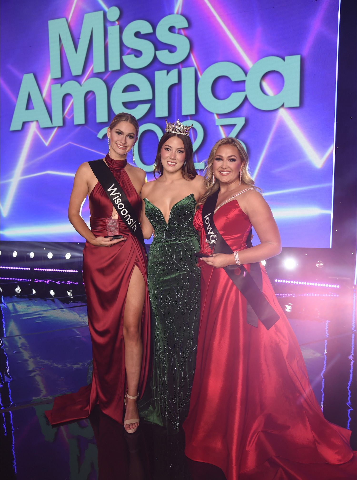 Miss America 2023 Preliminary Night 2 Winners Miss Iowa and Miss Wisconsin pose on stage with Miss America 2022, Emma Broyles